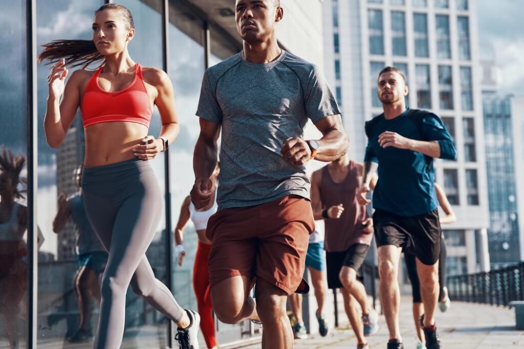 Runners on a city street, illustrating the active patients treated for foot and ankle sports injuries at CarePlus in Bellevue